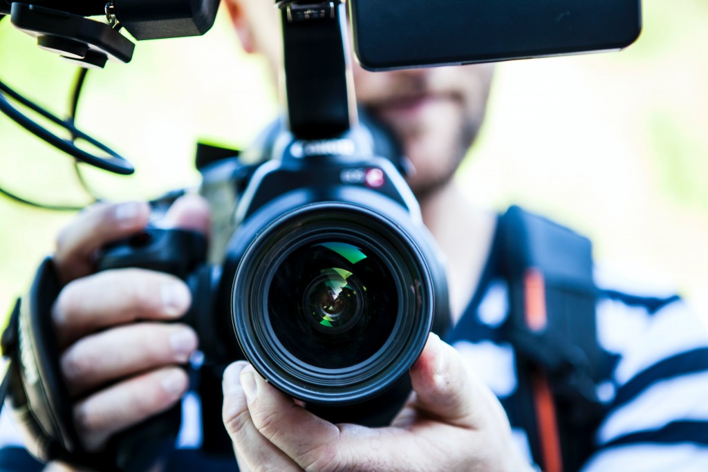 A man filming using a gimbol making the most from video.